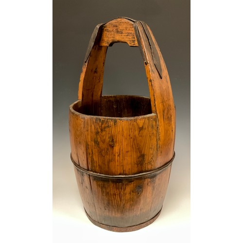 862 - A 19th century wrought iron bound, Asian rice bucket, 60cm high.