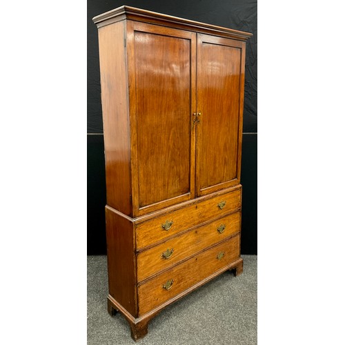 1213 - A George III mahogany bookcase on chest, having an outswept moulded cornice to the top, over a pair ... 