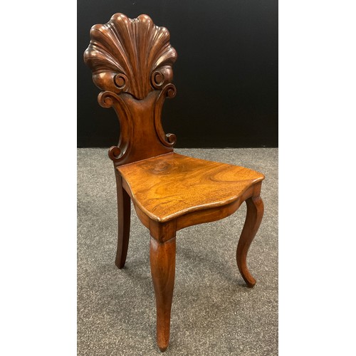 911 - A similar pair of 19th century walnut hall chairs, the carved scallop backs with c-scroll sides, ove... 