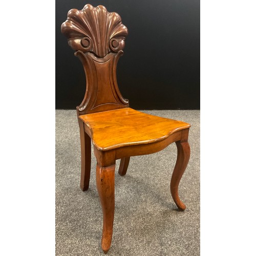 911 - A similar pair of 19th century walnut hall chairs, the carved scallop backs with c-scroll sides, ove... 