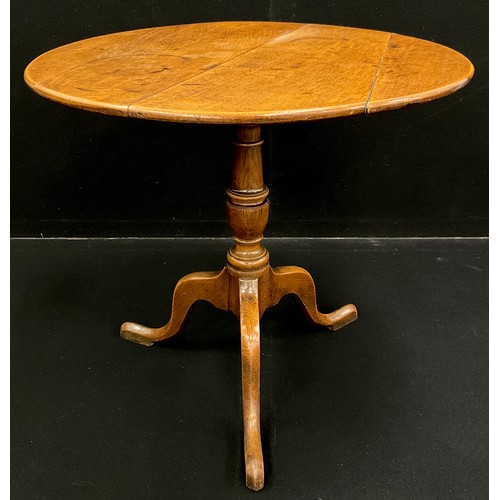 1065 - A George III oak tripod table, circular, quarter-sawn oak top with good figure, baluster-form pedest... 