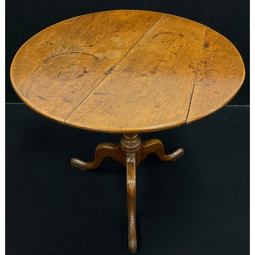 1065 - A George III oak tripod table, circular, quarter-sawn oak top with good figure, baluster-form pedest... 