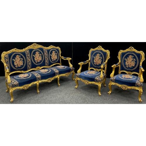 1058 - A Louis XIV style carved gilt-wood effect sofa, and pair armchairs, the sofa measuring 121cm high x ... 