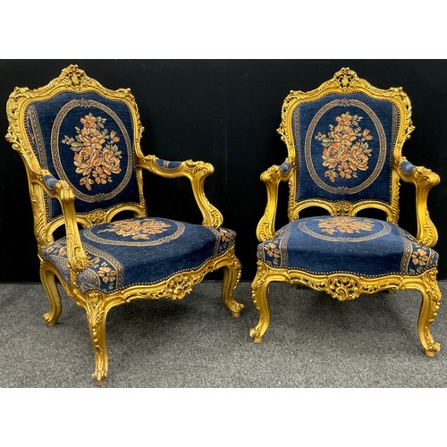 1058 - A Louis XIV style carved gilt-wood effect sofa, and pair armchairs, the sofa measuring 121cm high x ... 