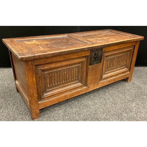 873 - An 18th century oak blanket chest, the two panel hinged top lifting to reveal the interior fitted wi... 