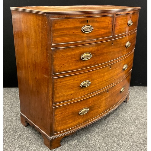 1043 - A George III mahogany bow-front chest of drawers, the satinwood cross-banded top with reeded edge, a... 