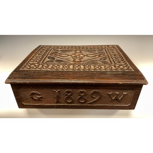 884 - A 19th century carved oak bible box, carved Celtic chain border, carved date 1889 to back, 38cm x 42... 