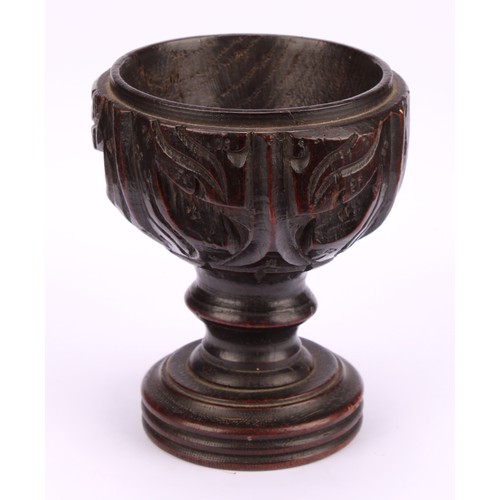 893 - A 19th century oak goblet or chalice, the bowl carved with acanthus, turned base, 14cm high,