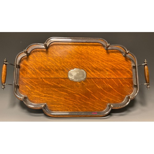 1224 - A late Victorian E.P.N.S mounted oak shaped serpentine two-handled gallery tray, bun feet, 59cm wide... 