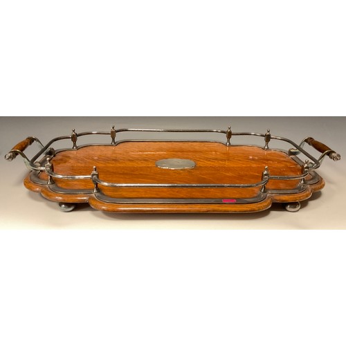 1224 - A late Victorian E.P.N.S mounted oak shaped serpentine two-handled gallery tray, bun feet, 59cm wide... 