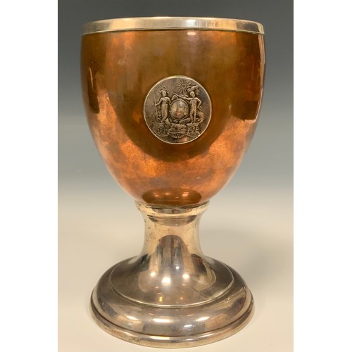 1221 - A 19th century silver coloured metal and copper pedestal goblet, applied with the badge of the Kit C... 