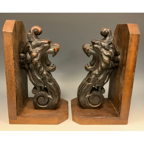 1246 - A pair of substantial oak country house book ends, each boldly carved with the head of lion terminat... 