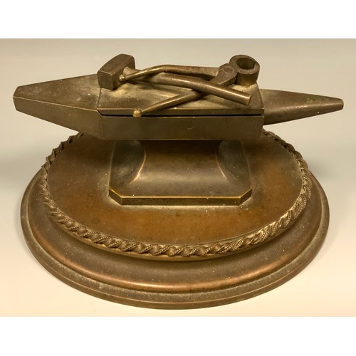 883 - A 19th century bronze novelty table vesta, as a blacksmith's anvil, the hinged cover with hammer and... 