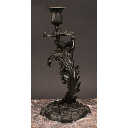 1230 - A pair of 19th century dark patinated bronze mantle sticks, cast with cherubs flying amongst stylise... 