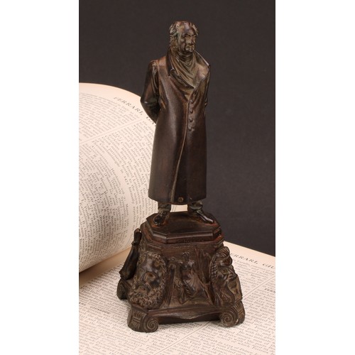 1251 - Continental school, 19th century, a bronzed iron figure of a figure standing wearing a long jacket a... 