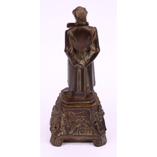 1251 - Continental school, 19th century, a bronzed iron figure of a figure standing wearing a long jacket a... 