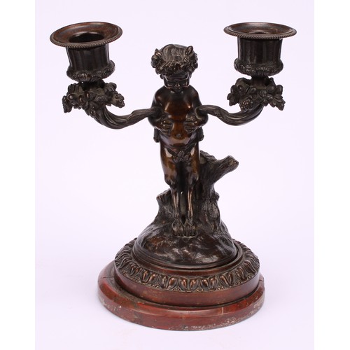 1231 - A pair of 19th century French figural two-light mantle candelabrum, cast as fauns standing holding f... 