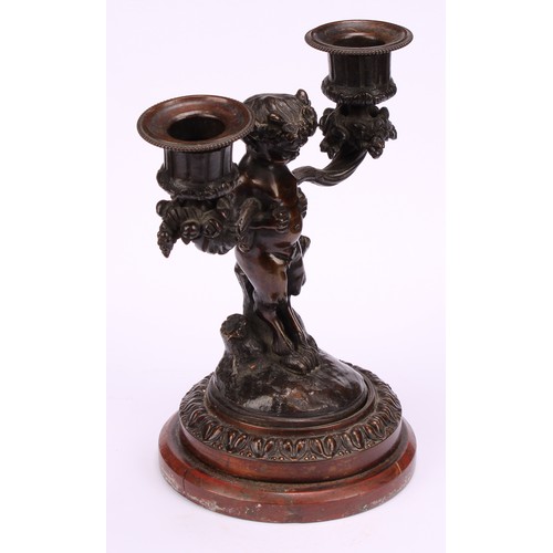 1231 - A pair of 19th century French figural two-light mantle candelabrum, cast as fauns standing holding f... 