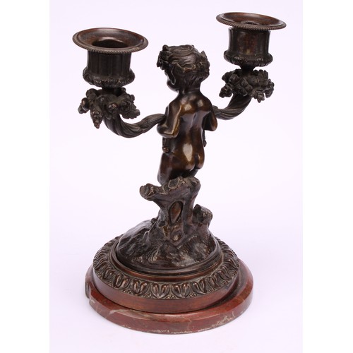 1231 - A pair of 19th century French figural two-light mantle candelabrum, cast as fauns standing holding f... 