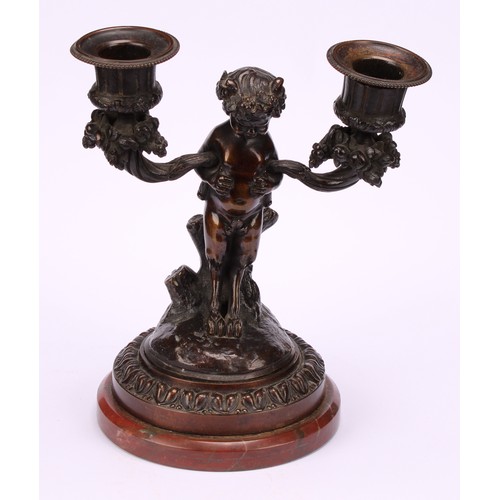 1231 - A pair of 19th century French figural two-light mantle candelabrum, cast as fauns standing holding f... 