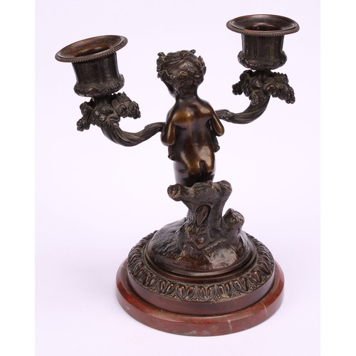 1231 - A pair of 19th century French figural two-light mantle candelabrum, cast as fauns standing holding f... 