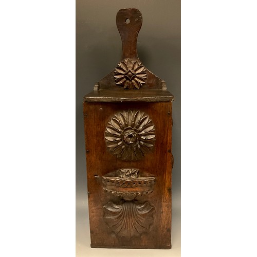 892 - A 19th century oak candle box, carved and applied with flowerhead bosses, shells and Neo-Classical d... 