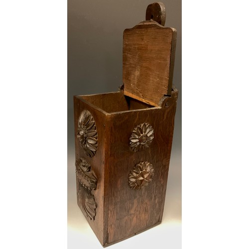 892 - A 19th century oak candle box, carved and applied with flowerhead bosses, shells and Neo-Classical d... 