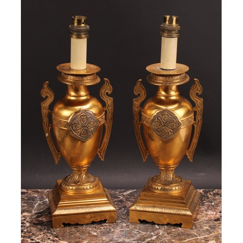 1025 - A pair of French Grecian Revival gilt bronze ovoid table lamps, cast and chased with palmettes and a... 