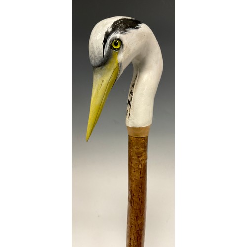 670 - A trio of hand-carved walking canes, each of the handles carved and painted as the head of a Heron i... 