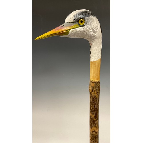 670 - A trio of hand-carved walking canes, each of the handles carved and painted as the head of a Heron i... 