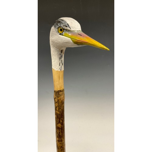 670 - A trio of hand-carved walking canes, each of the handles carved and painted as the head of a Heron i... 