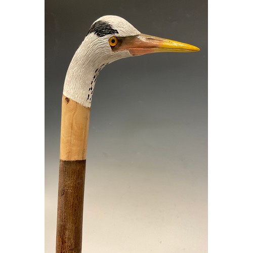 670 - A trio of hand-carved walking canes, each of the handles carved and painted as the head of a Heron i... 