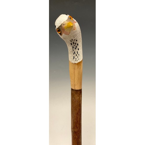 670 - A trio of hand-carved walking canes, each of the handles carved and painted as the head of a Heron i... 