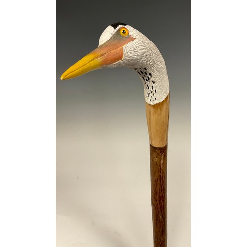 670 - A trio of hand-carved walking canes, each of the handles carved and painted as the head of a Heron i... 