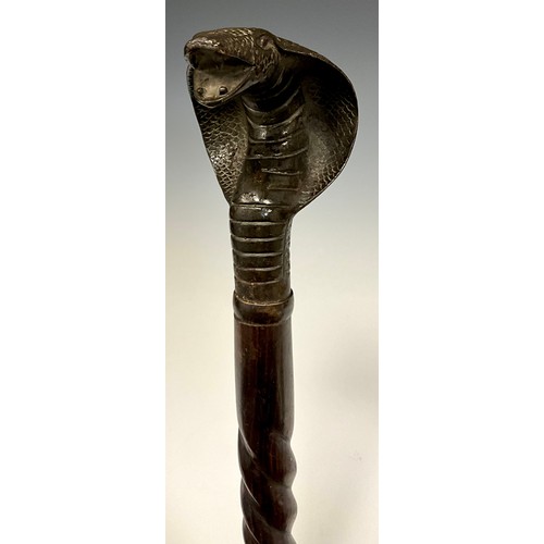 684 - A bronze Cobra handled walking stick, twisted tapering shaft, 84cm long.