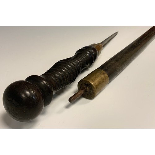 691 - A 19th century hardwood and brass sword stick, turned twist off handle revealing a quattro form tape... 