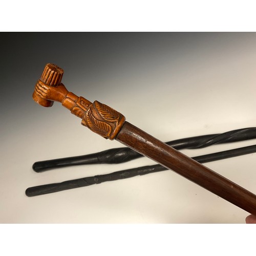 693 - An Irish folk art, carved bog oak walking stick, carved with spreading tendrils of clover to upper h... 