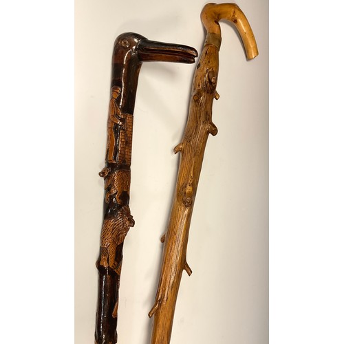 694 - An interesting folk or possible trench art, carved walking stick, the handle carved as the head of a... 