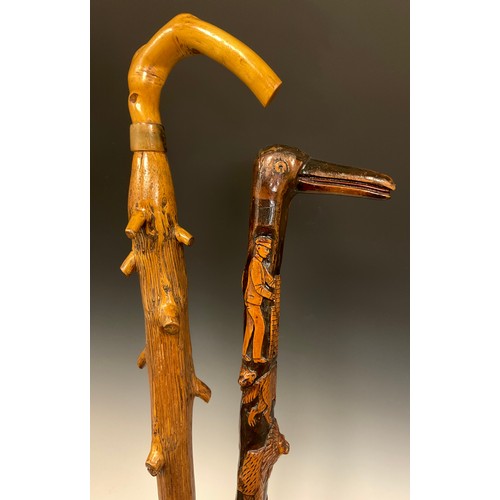 694 - An interesting folk or possible trench art, carved walking stick, the handle carved as the head of a... 