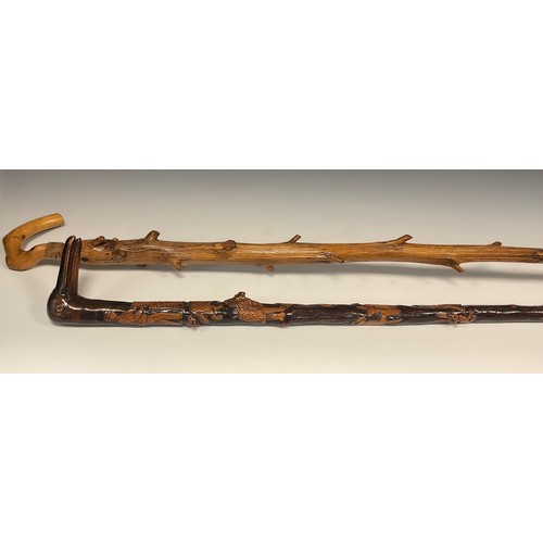 694 - An interesting folk or possible trench art, carved walking stick, the handle carved as the head of a... 