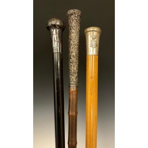 696 - A 19th century Anglo-Indian walking cane, the handle chased in relief with scrolling leafy fronds, s... 