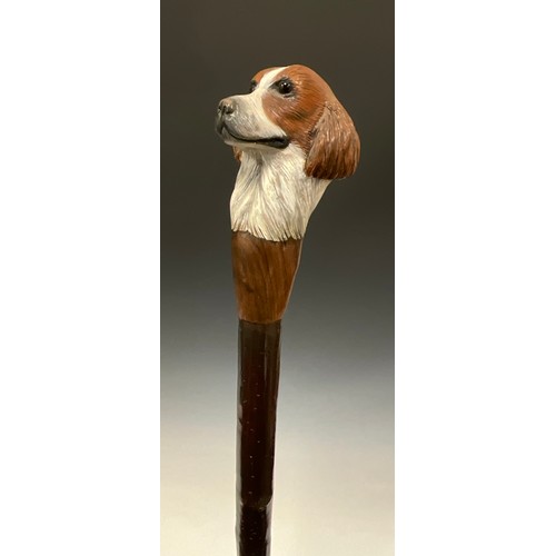 706 - A carved wooden walking stick, by Mike Wood, the handle carved and painted as the head of a Spaniel,... 