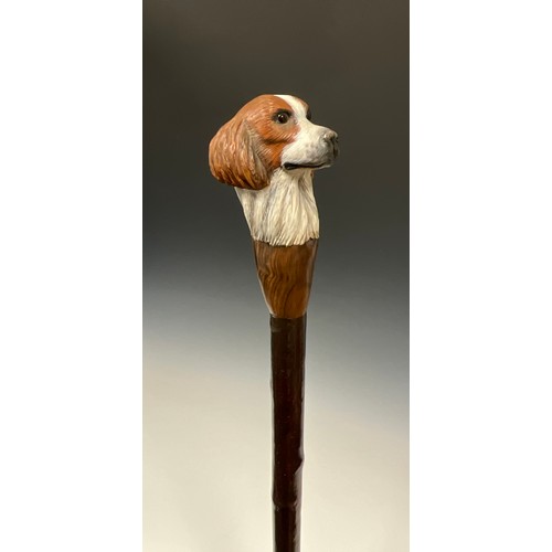 706 - A carved wooden walking stick, by Mike Wood, the handle carved and painted as the head of a Spaniel,... 