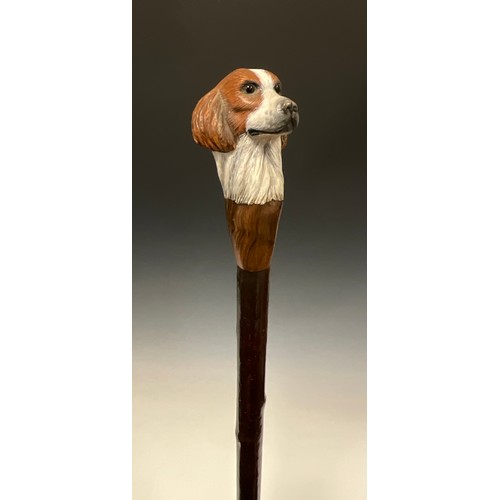 706 - A carved wooden walking stick, by Mike Wood, the handle carved and painted as the head of a Spaniel,... 