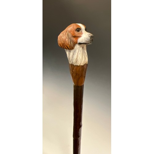 706 - A carved wooden walking stick, by Mike Wood, the handle carved and painted as the head of a Spaniel,... 