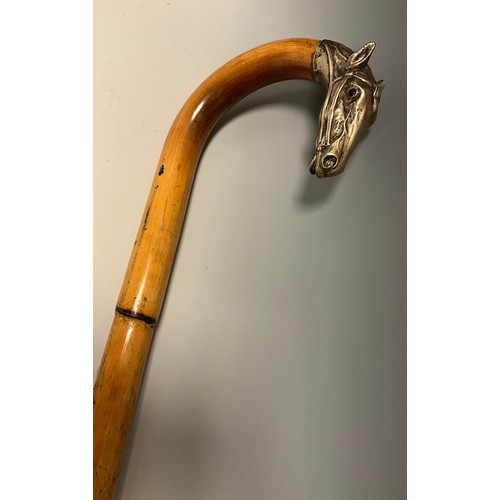 708 - A late 19th century bamboo walking stick, the handle terminal cast in silver metal as the head of a ... 