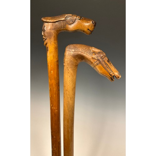 709 - A late 19th / early 20th century Russian folk art walking stick / walking cane, the handle carved as... 