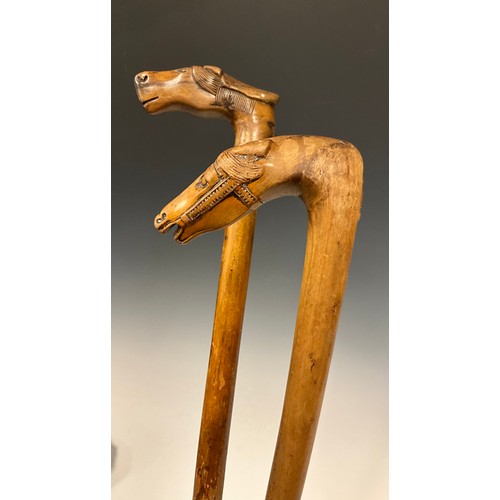 709 - A late 19th / early 20th century Russian folk art walking stick / walking cane, the handle carved as... 