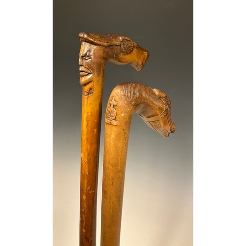 709 - A late 19th / early 20th century Russian folk art walking stick / walking cane, the handle carved as... 