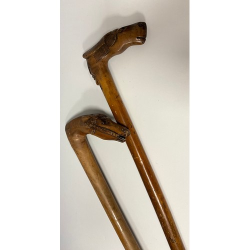 709 - A late 19th / early 20th century Russian folk art walking stick / walking cane, the handle carved as... 